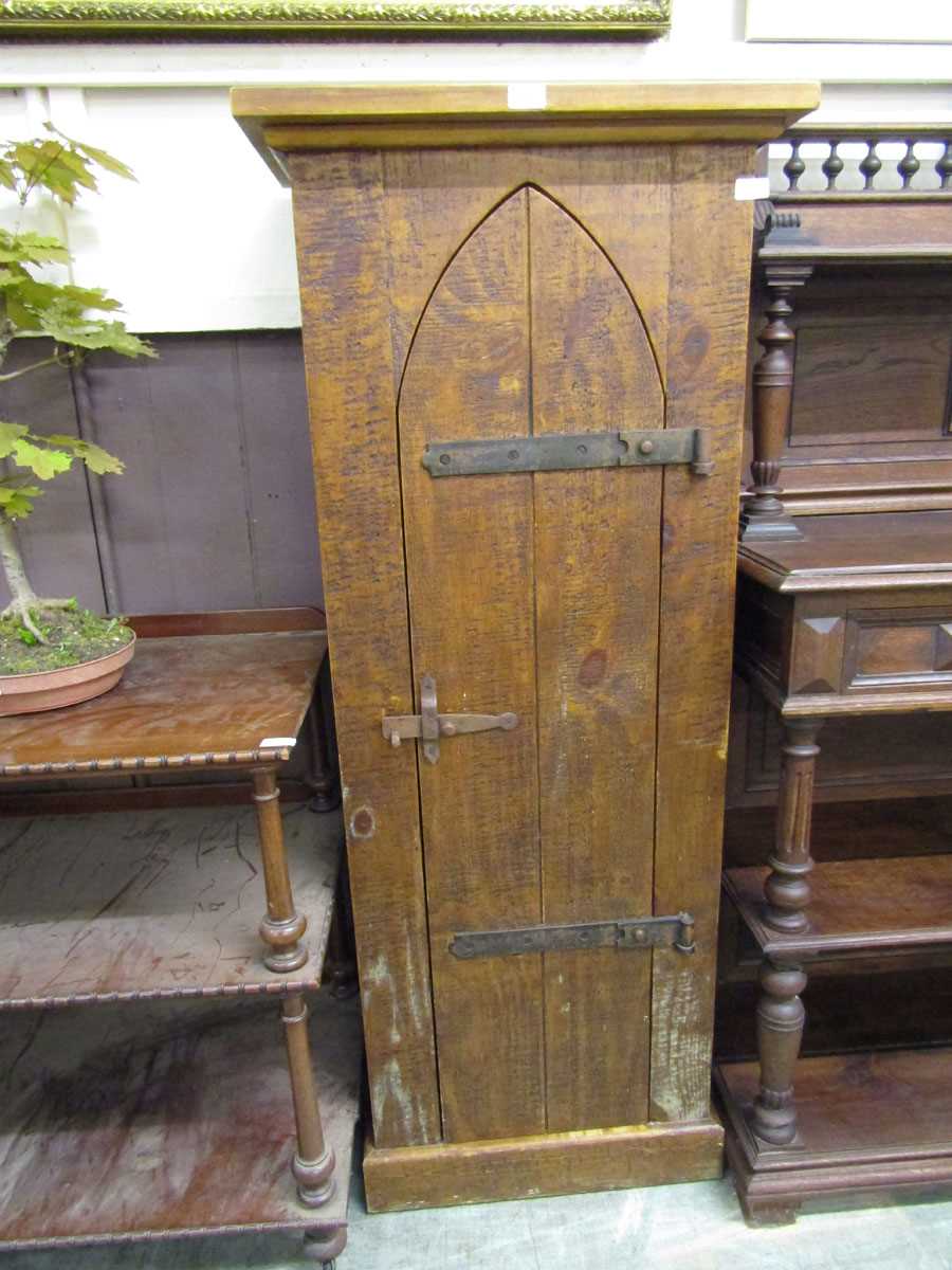 An Indonesian hardwood gothic style cupboard having an arch topped chapel style door
