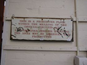 An enamelled sign starting 'This Is A Prohibited Area.....'