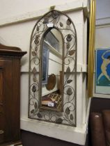 A metal leaf design framed arch top wall mirror