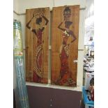 A pair of wooden wall plaques depicting African ladies