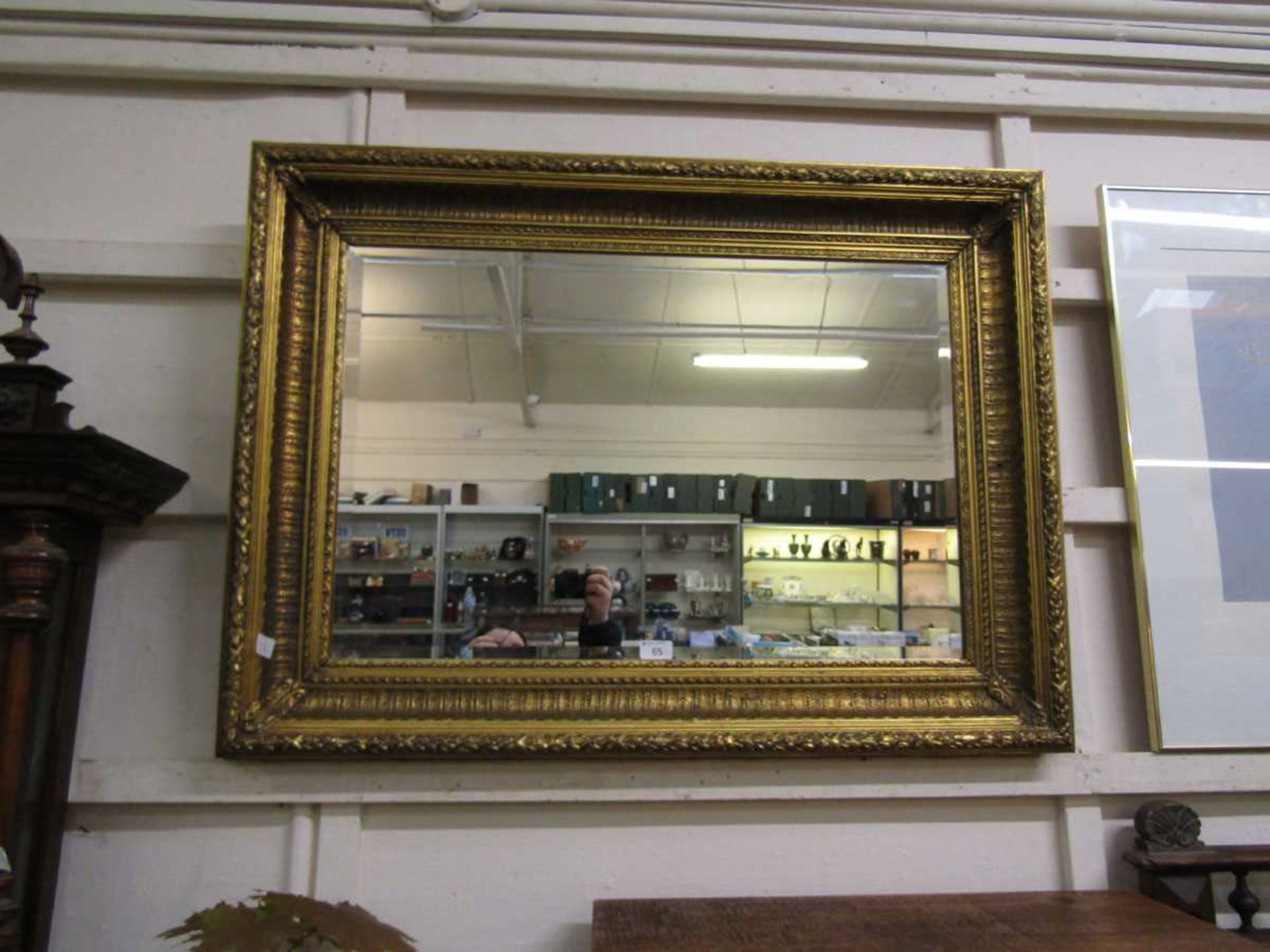 A reproduction ornate gilt framed rectangular bevel glass wall mirror