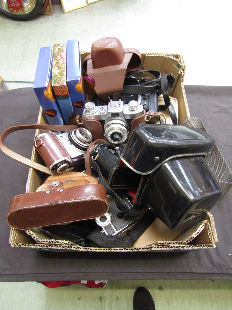 A box containing a quantity of old cameras to include Halina , Nikon, etc