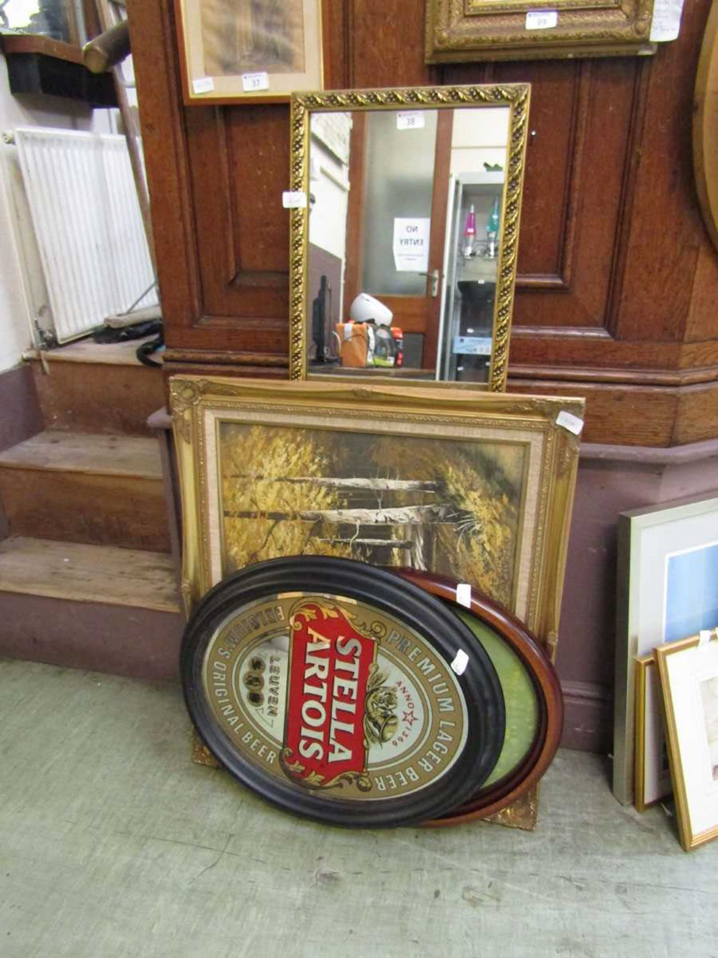 A selection including two prints, a Stella advertising mirror and a rectangular gilt framed wall