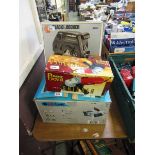 A boxed angle grinder along with a boxed Black and Decker rotary saw and a boxed table saw