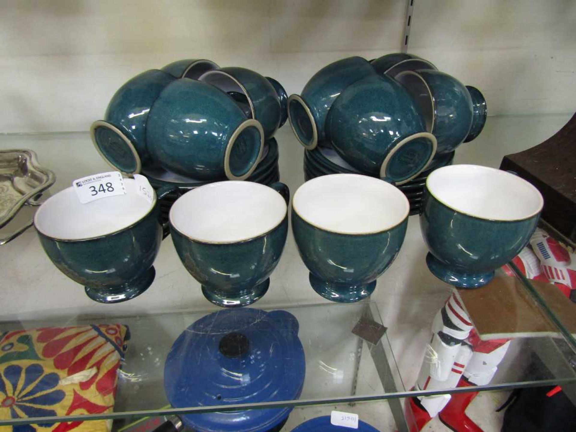 A set of twelve blue ground mid-20th century style teacups and saucers by Denby