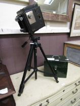 A boxed Ensign Deluxe Reflux with roll filter back and second back with quick release tripod