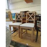 A pair of modern oak framed dining chairs