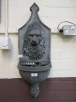 A production moulded wall mounted water feature with lion design