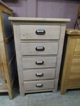 A lime washed modern pine chest of five drawers