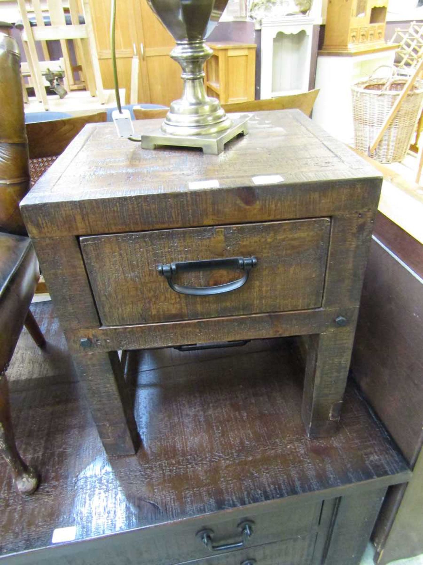 A reproduction rough cut wooden cabinet with single drawer