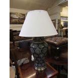 A reproduction blue ceramic table lamp with shade