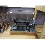 A cased Singer manual sewing machine