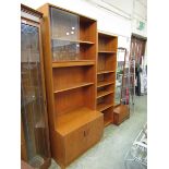 A G-Plan mid-20th century teak unit having a glazed sliding door top section above open storage with