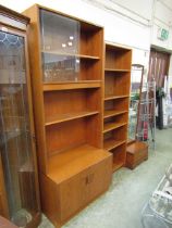 A G-Plan mid-20th century teak unit having a glazed sliding door top section above open storage with