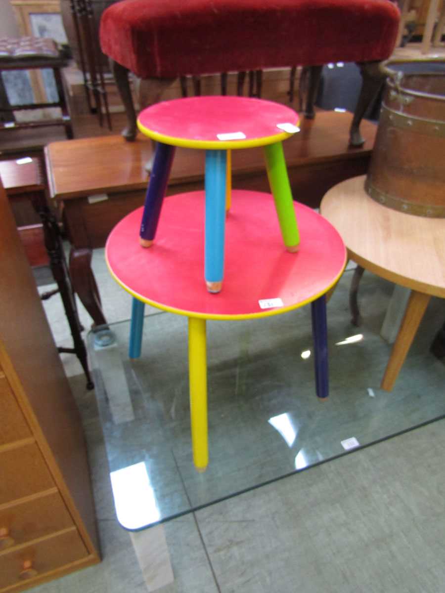 A multi-coloured painted circular topped children's table with matching stool