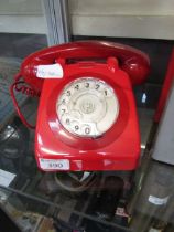 A red dial telephone