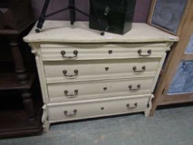 A French painted pine chest of four long graduated drawers