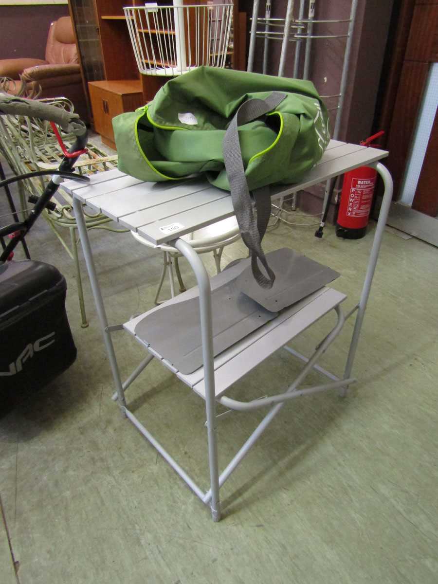 A modern folding camping table with green bag