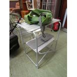 A modern folding camping table with green bag