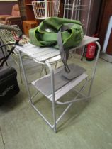 A modern folding camping table with green bag