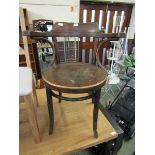 An early 20th century open arm chair with embossed ply seat