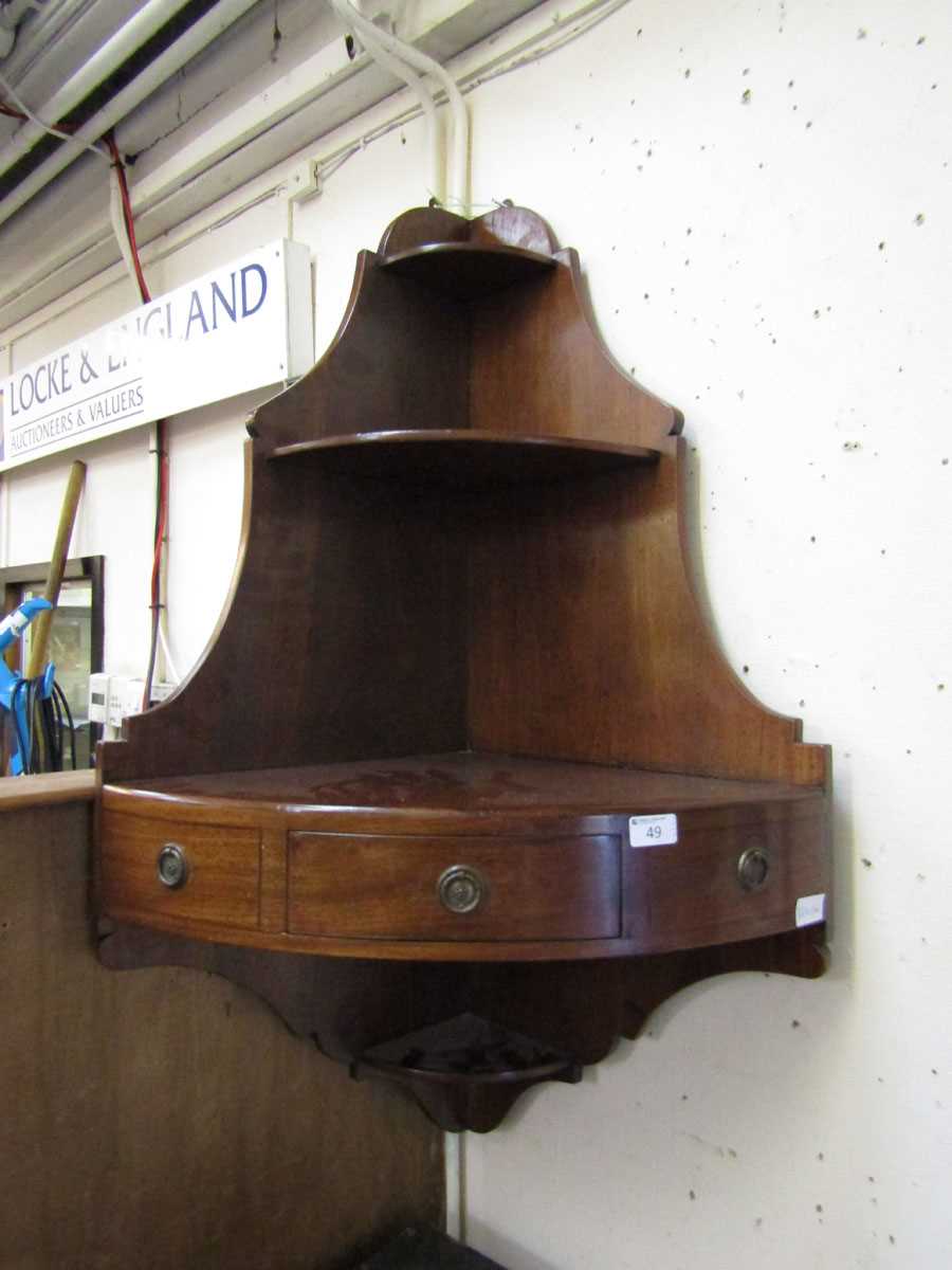 A Victorian mahogany wall mounted corner cabinet having open storage above a shelf with single