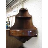 A Victorian mahogany wall mounted corner cabinet having open storage above a shelf with single