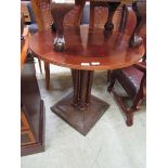 A reproduction circular mahogany parquet effect topped table with four turned columned wooden