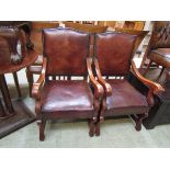 A pair of French style mahogany framed open chairs upholstered in a tan leather with studded