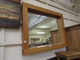 A modern oak framed wall mirror