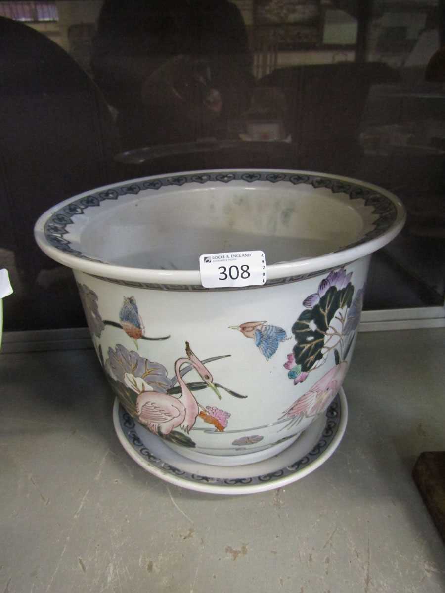 An oriental ceramic planter with bird decoration along with matching plate