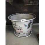 An oriental ceramic planter with bird decoration along with matching plate