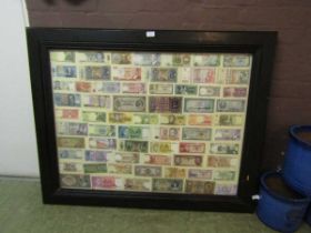 A large framed and mounted selection of currency from various countries