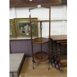 An early 20th century three tier oak folding cake stand