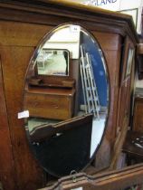 An early 20th century oak framed bevel glass wall mirror