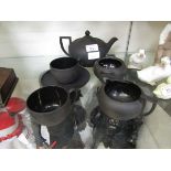 An assortment of black ground Wedgwood tableware to include teapot, cups, saucers, etc