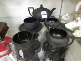 An assortment of black ground Wedgwood tableware to include teapot, cups, saucers, etc