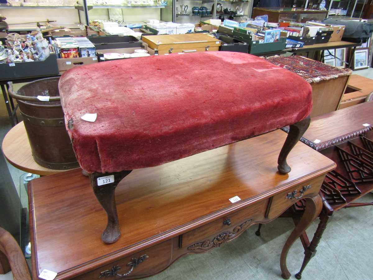 A mahogany cabriole legged stool with a distressed red velvet overstuffed seat
