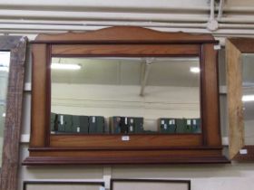 A reproduction oak over mantle mirror