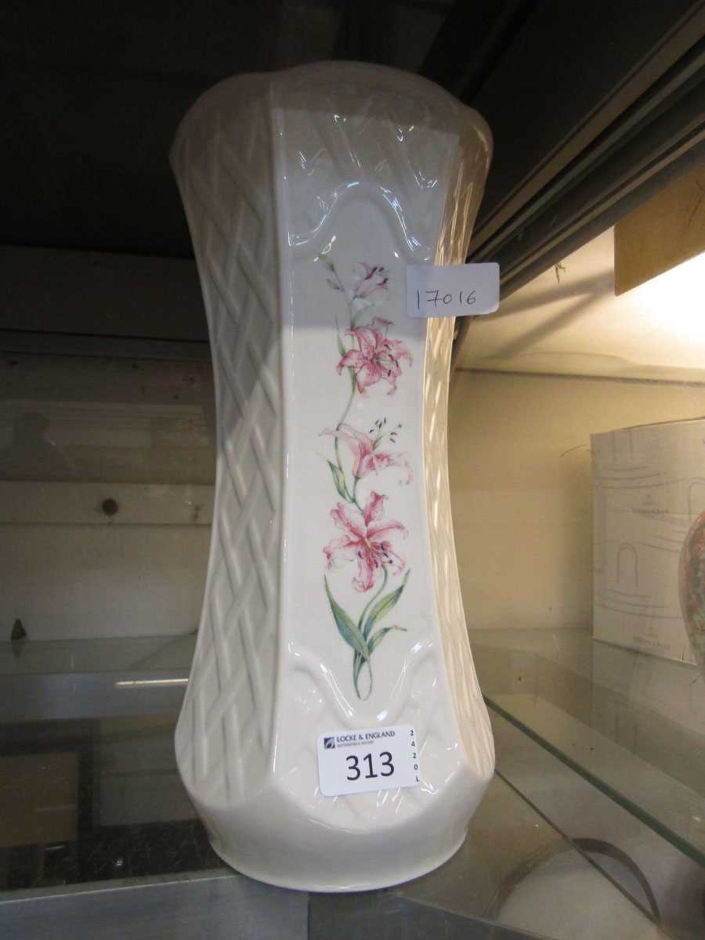 A white ground hexagonal ceramic vase with pink floral decoration by Belleek