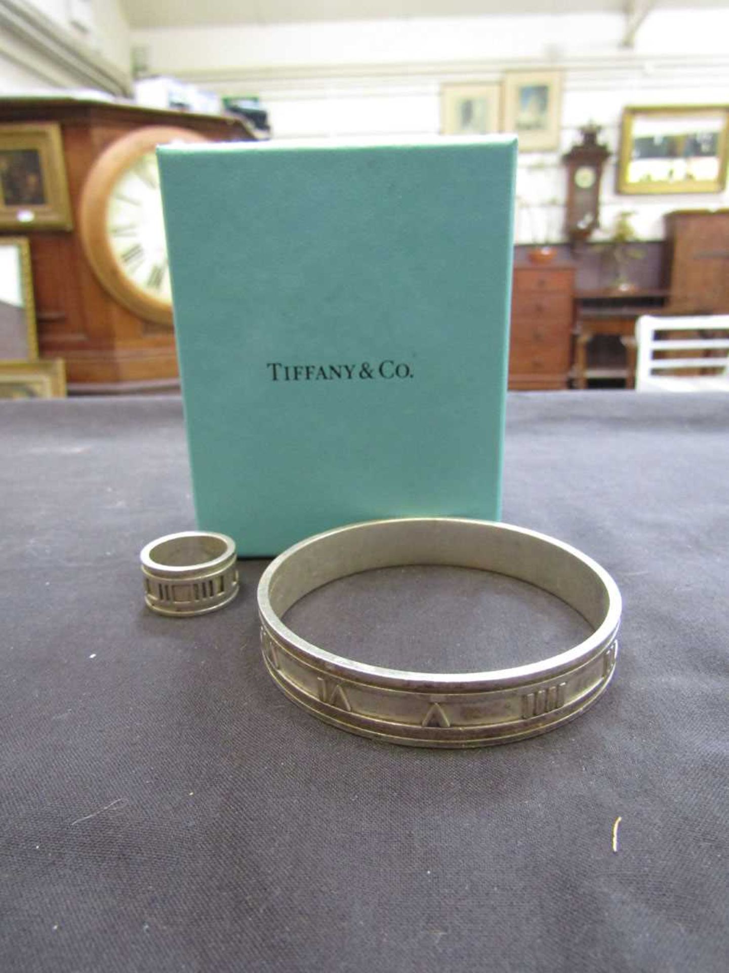 A white metal 'Atlas' design bangle marked 'Tiffany' together with a matching ring