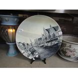 An early 20th century grey ground ceramic charger depicting canal scene