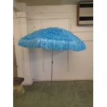 A modern Hawaiian grass style pale blue garden parasol