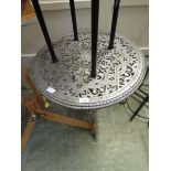 A silver sprayed metalwork garden table