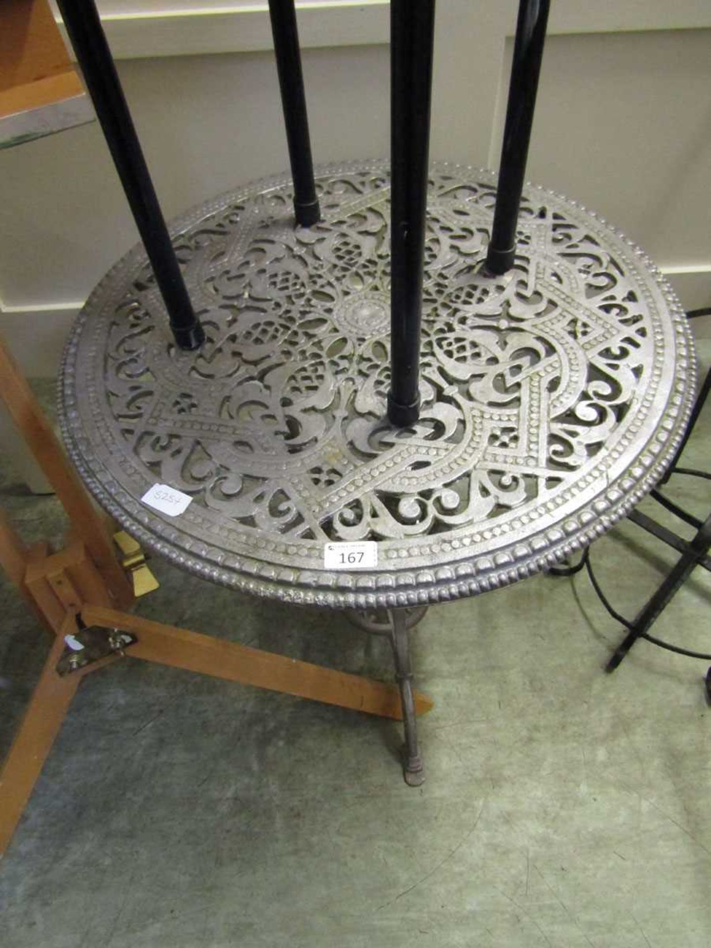 A silver sprayed metalwork garden table