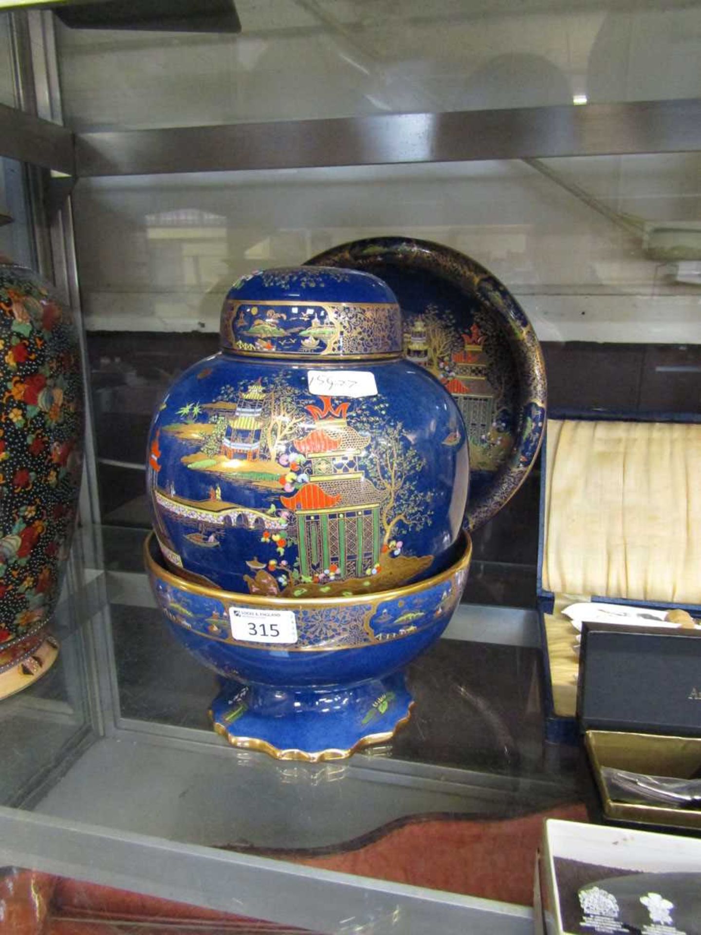 A blue ground oriental gilt design ginger jar by Carlton Ware along with matching bowl and dish