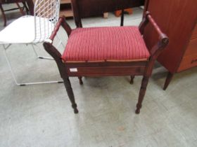 An Edwardian walnut music stool