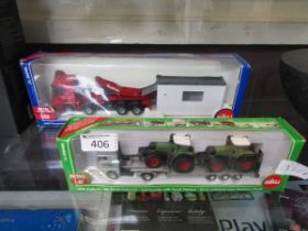 Two boxed die cast lorries, one with two tractors aboard