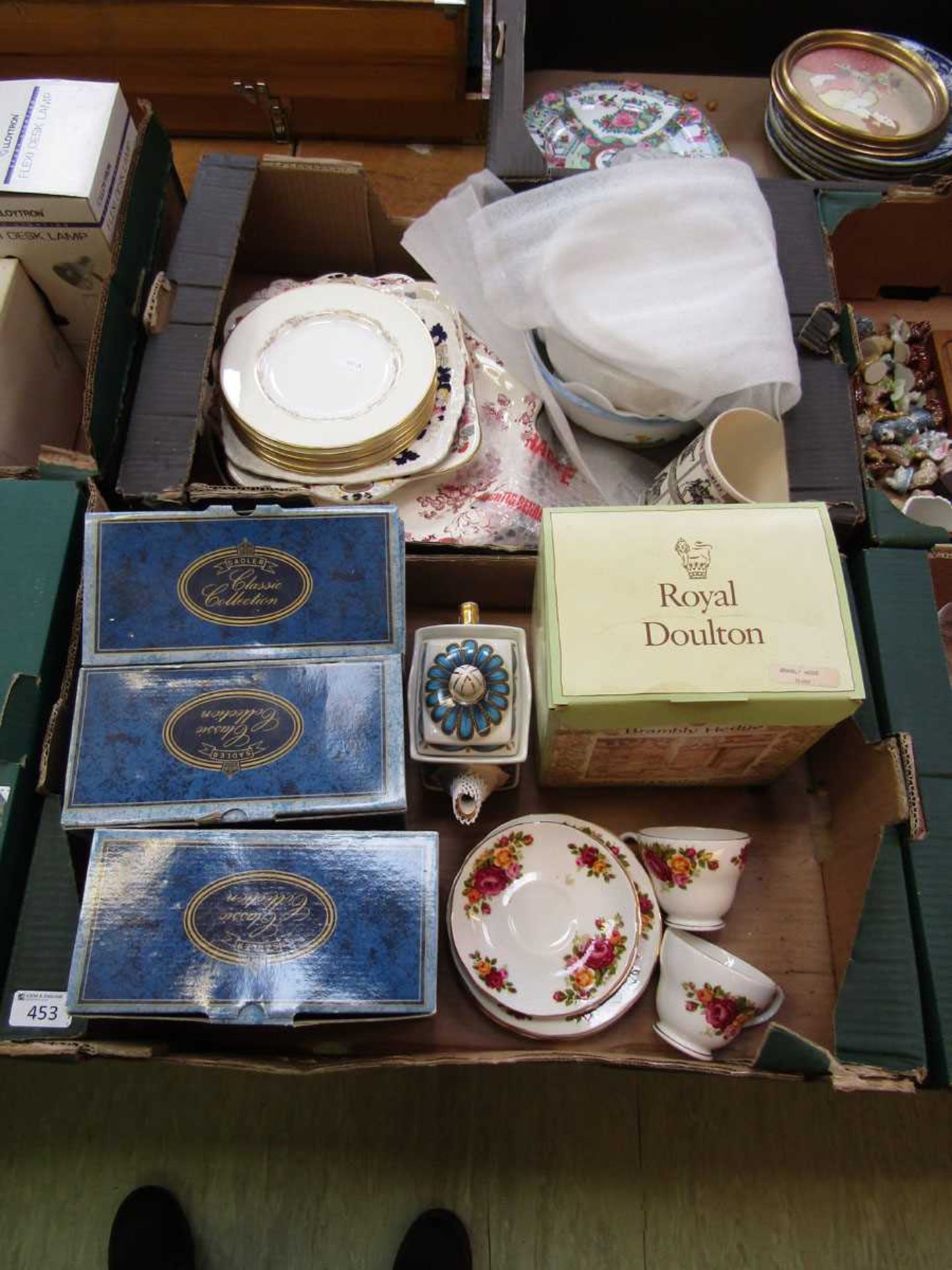 Two trays containing Sadler collector's teapots together with other decorative tea ware