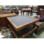 A mid-20th century teak low level table with slate top